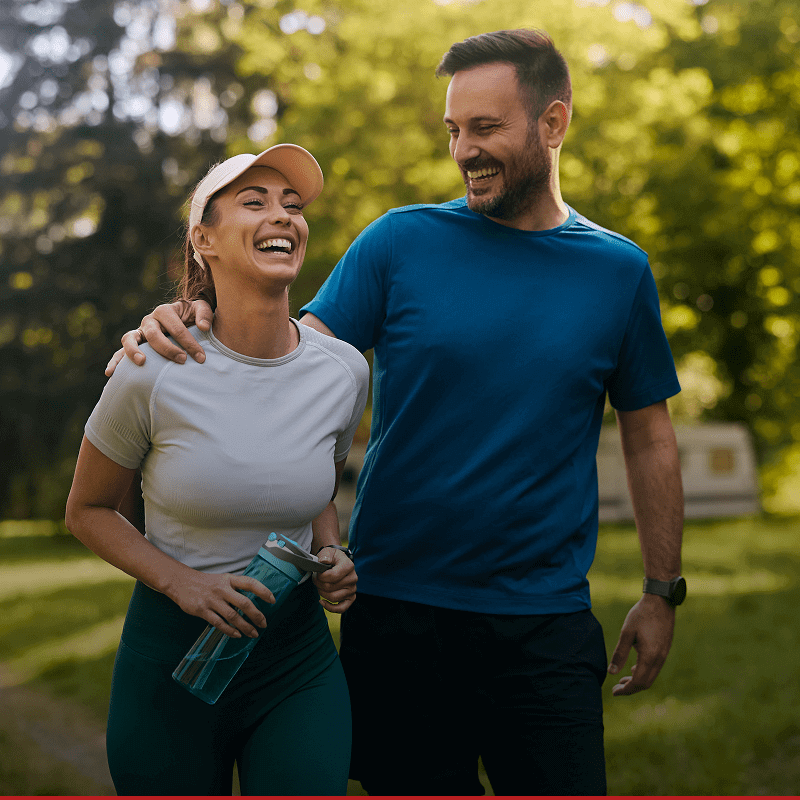 Smiling couple jogging in the park.