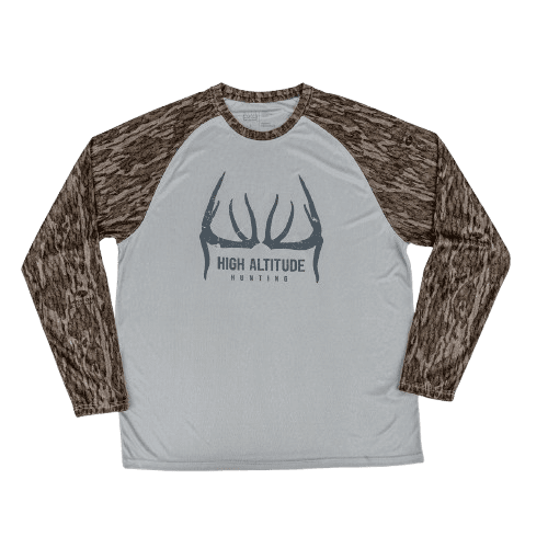 Long-sleeve hunting shirt with camouflage sleeves and deer antlers logo.